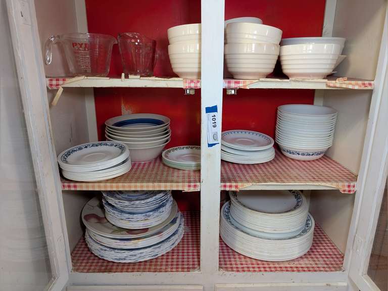 CONTENTS OF UPPER CABINET MARKED 1019 INCLUDING GLASS MEASURING CUPS, BOWLS MARKED USA, CORELLE DISHES, ARCOPAL FRANCE DISHES, AND MORE image