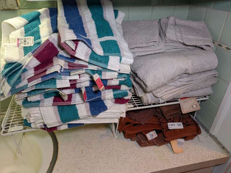 ALL TOWELS AND WIRE STAND IN COUNTER AREA MARKED 1323, MANY WITH ORIGINAL TAGS image
