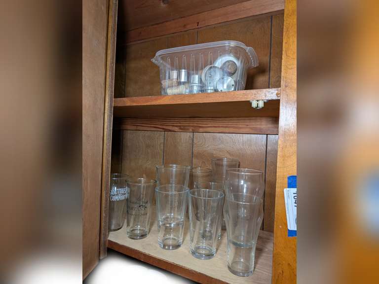 GLASSWARE AND VINTAGE COOKIE CUTTERS IN UPPER CABINET MARKED 1047 image