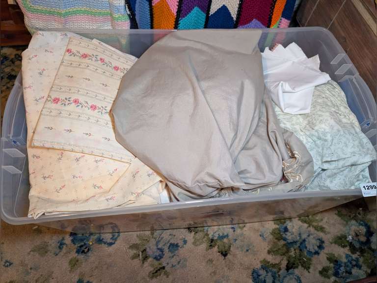 STORAGE TUB FILLED WITH BED LINENS image