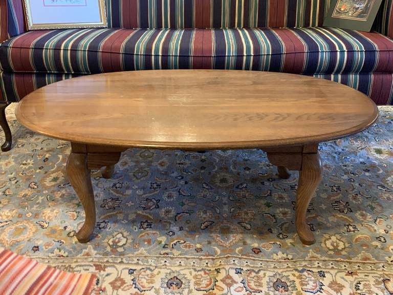 SOLID OAK OVAL COFFEE TABLE 45" LONG X 27" WIDE X 17" TALL (SOME DAMAGE ON TOP - SEE PIC) image