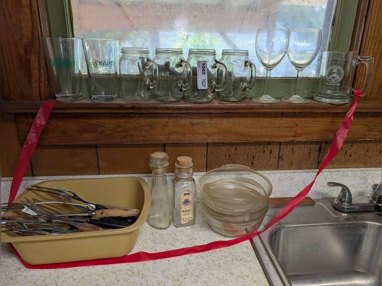 MASON JAR MUGS, STEMS, MEAT FORKS, AND MORE IN COUNTER AREA AND WINDOWSILL ABOVE MARKED 1045 image