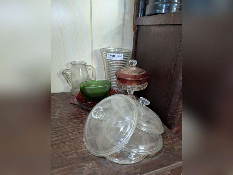 VINTAGE GLASS IN CABINET TOP AREA MARKED 1108 INCLUDED DIVIDED SERVING BOWL, ART GLASS LIDDED COMPOTE CANDY DISH, BOOPY FOOT GLASS VASE, CASSEROLE DISH LIDS, AND MORE image
