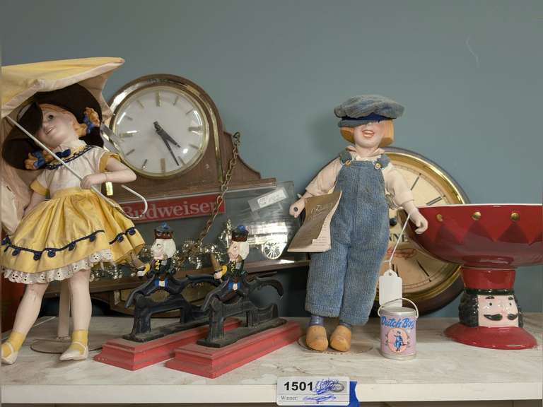 VINTAGE BUDWEISER AND GUINNESS BEER CLOCKS, COLLECTIBLE DOLLS, CAST IRON NUTCRACKERS, AND MORE ON TOP OF CABINET MARKED 1501 image