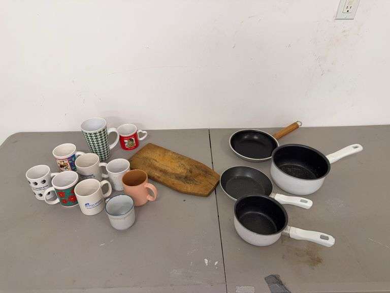 Assorted Kitchen Items: Mugs, Pans, and Cutting Board image