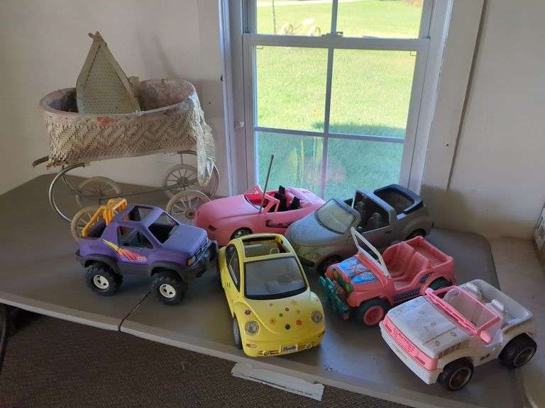 Assorted Toy Vehicles Including Barbie Cars and Stroller