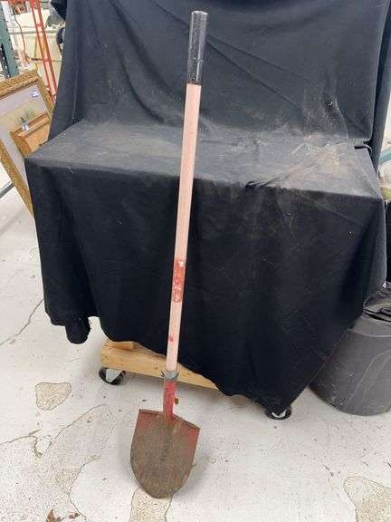 Vintage Shovel with Red Metal Head and Wooden Handle image