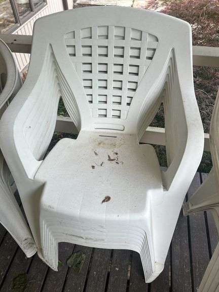 Stack of White Plastic Outdoor Chairs image