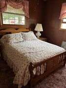 Full Size Wooden Bed Frame with Floral Quilt