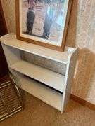 Framed Print, White Shelf, Stool, and Magazine Rack