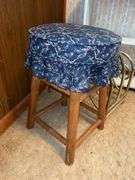 Framed Print, White Shelf, Stool, and Magazine Rack