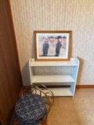 Framed Print, White Shelf, Stool, and Magazine Rack