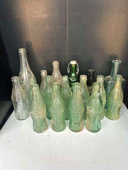 Collection of Various Glass Bottles Including Coca-Cola and Grassi image