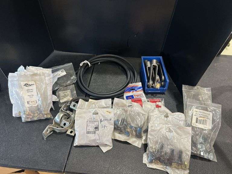 Assorted Farm Equipment Parts: Belts, Hoses, Bolts, and More image