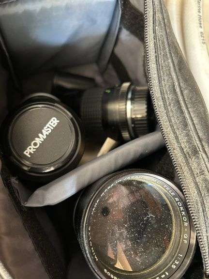 Camera lenses in bag with chemicals, hose and cooler