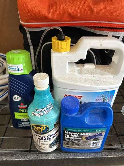 Camera lenses in bag with chemicals, hose and cooler