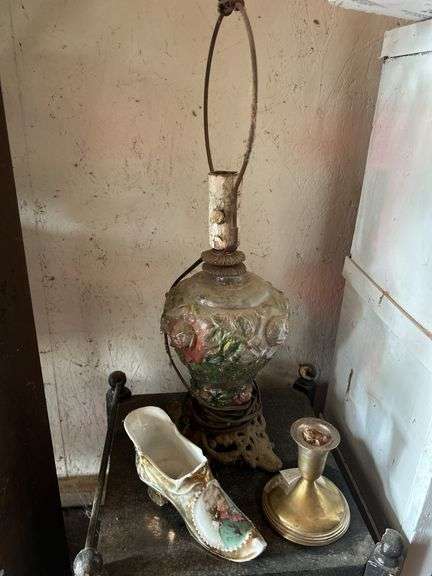 Small Black Cabinet with Lamp, Shoe, and Candlestick image