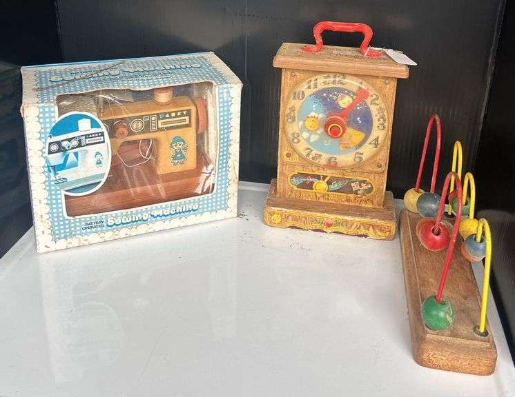 Toy Sewing Machine, Fisher Price Clock, and Bead Toy image