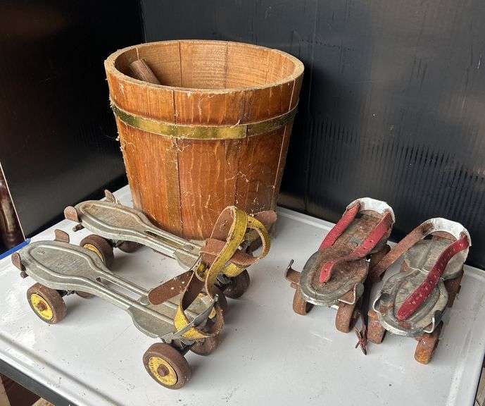 Two Pairs of Roller Skates with Wood Bucket image