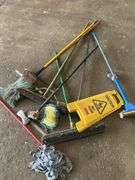 Assorted Cleaning Supplies: Mops, Brooms, and Caution Sign