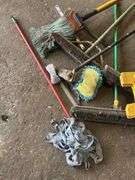 Assorted Cleaning Supplies: Mops, Brooms, and Caution Sign