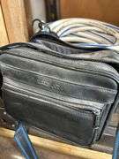 Camera lenses in bag with chemicals, hose and cooler