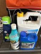 Camera lenses in bag with chemicals, hose and cooler