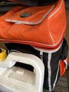 Camera lenses in bag with chemicals, hose and cooler