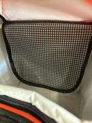 Camera lenses in bag with chemicals, hose and cooler