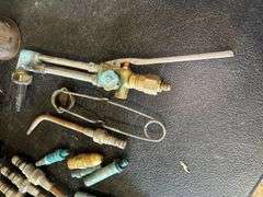Assorted Tools: Grease Gun, Torches, and Oil Cans