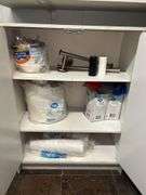 Storage Cabinet with Contents and Trash Can