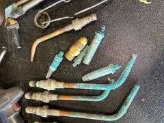 Assorted Tools: Grease Gun, Torches, and Oil Cans