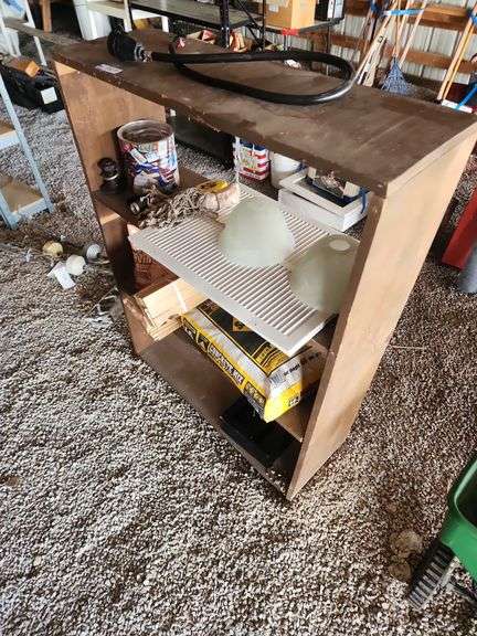 Wooden Shelf with Concrete Mix, Metal Grate, and Assorted Items image