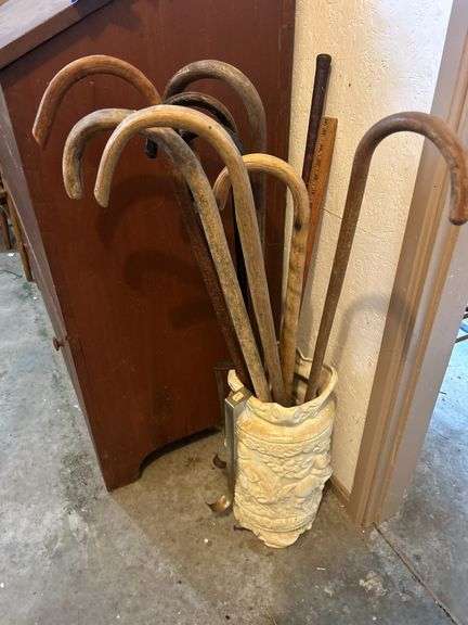Group of Walking Sticks in Ornate Planter Stand image