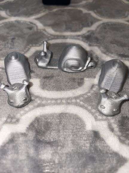 THREE 3D PRINTED CELL PHONE HOLDERS.  CELL PHONE NOT INCLUDED image
