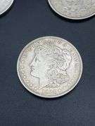 FIVE MORGAN SILVER DOLLARS