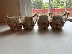 Set of Four "Shelah '84" Relief Design Pitchers