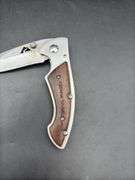 Three Pocket Knives: Smith & Wesson, Ozark Trail, and Tac-Force