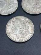 FIVE MORGAN SILVER DOLLARS