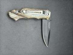 Three Pocket Knives: Smith & Wesson, Ozark Trail, and Tac-Force
