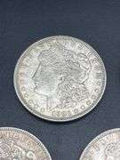 FIVE MORGAN SILVER DOLLARS