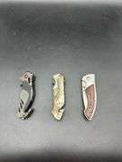 Three Pocket Knives: Smith & Wesson, Ozark Trail, and Tac-Force
