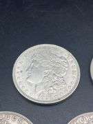 FIVE MORGAN SILVER DOLLARS