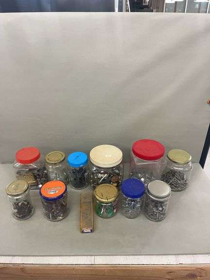 Variety of Nails, Screws, and Fasteners in Jars and Container image