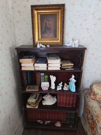 Shelf of Various Collectibles Including a Framed Portrait, Books and Figurines image