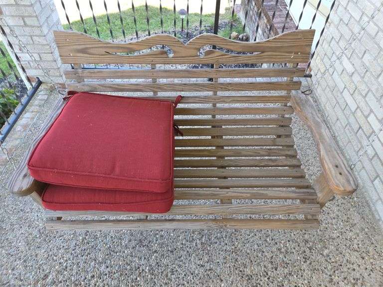 Wooden Porch Swing with Red Cushions image