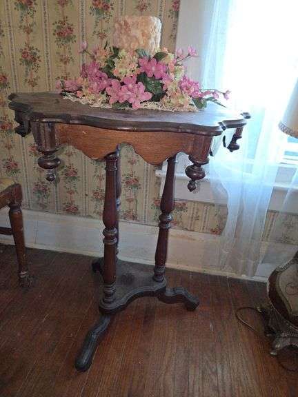 Small Wooden Parlor Table with Candle and Floral Arrangement image