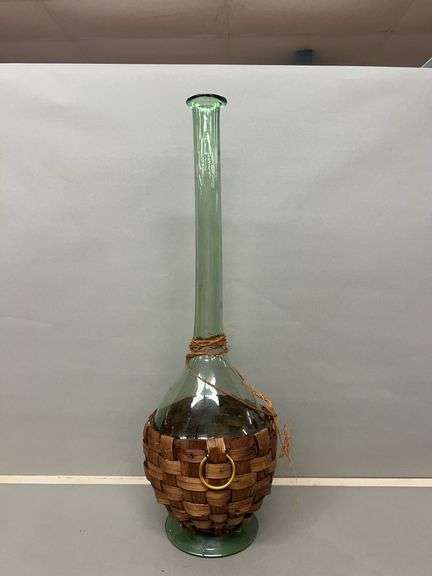 Tall Green Glass Bottle with Woven Basket Base image