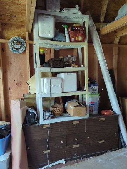 Shelving unit with assorted household items. image
