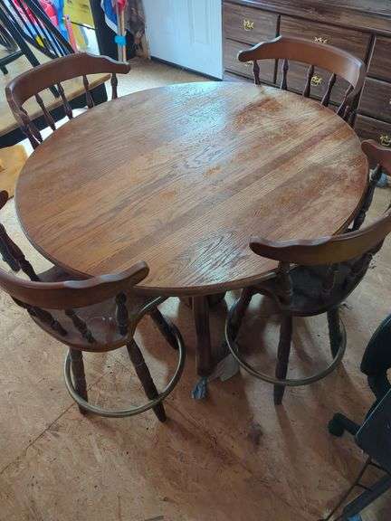 Round Wooden Dining Table with Four Swivel Chairs image